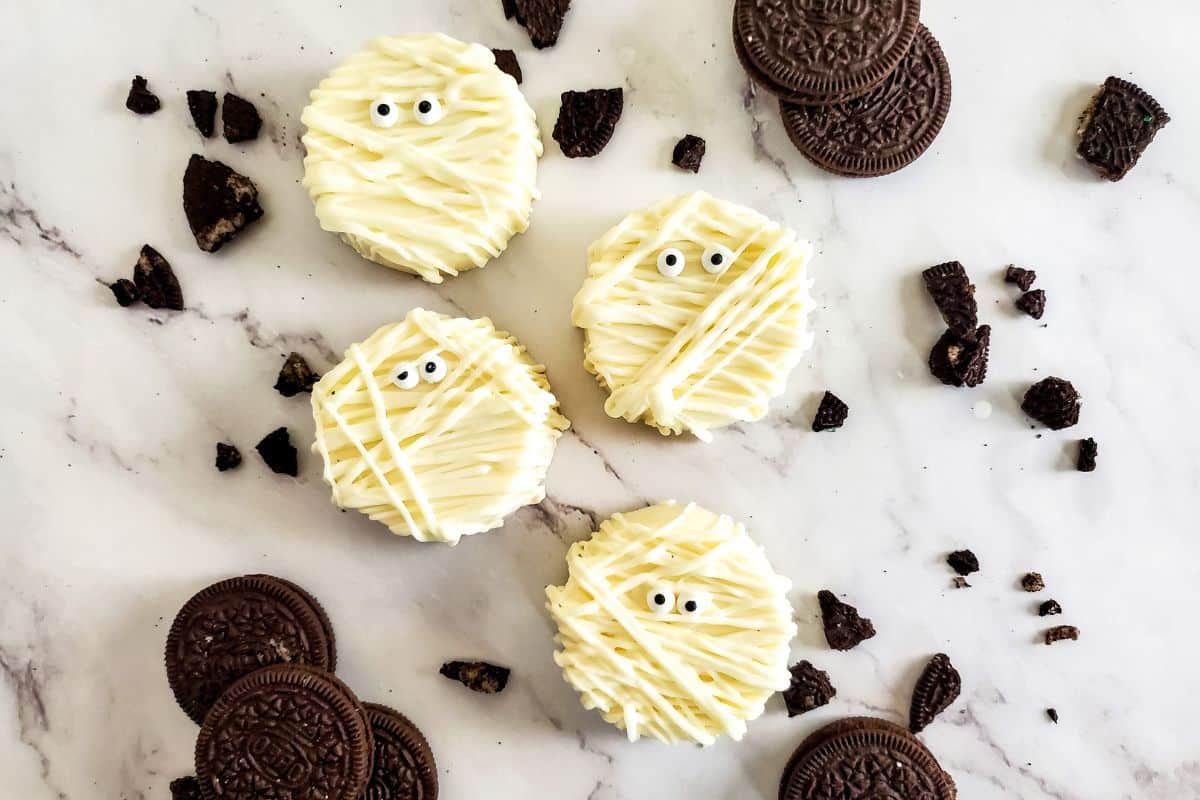 four mummy cookies with candy eyes 