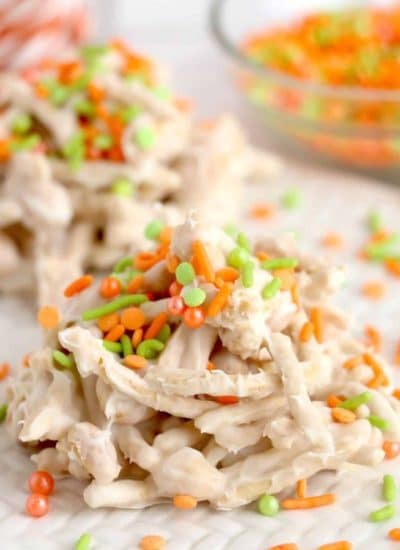 A plate of chicken noodle treats with sprinkles and candy.