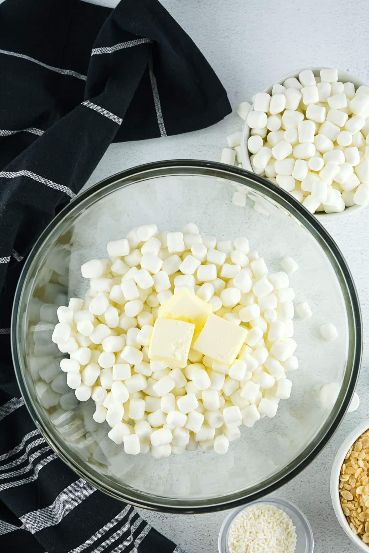 marshmallows and butter in clear mixing bowl
