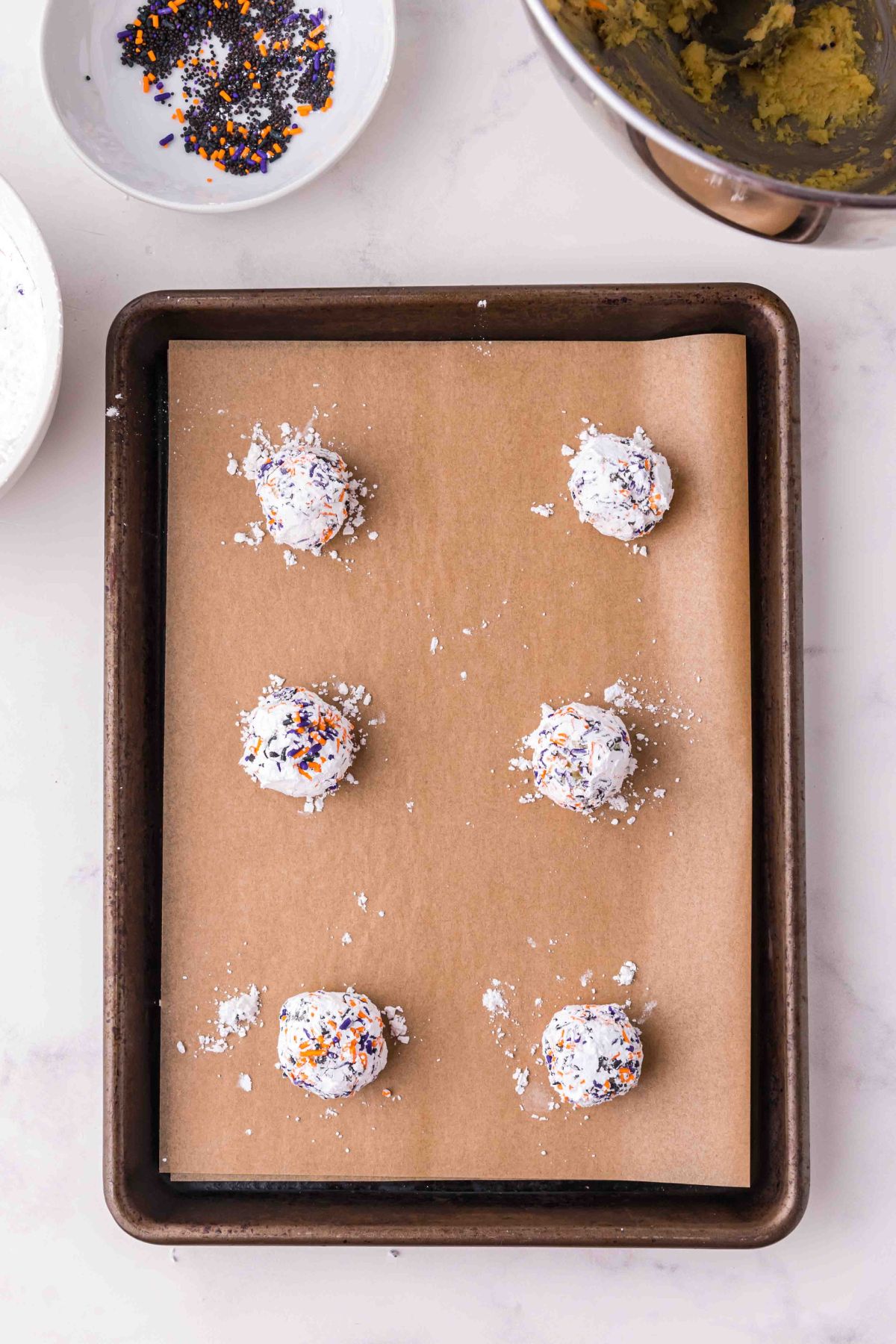 6 white balls on baking sheet with parchment