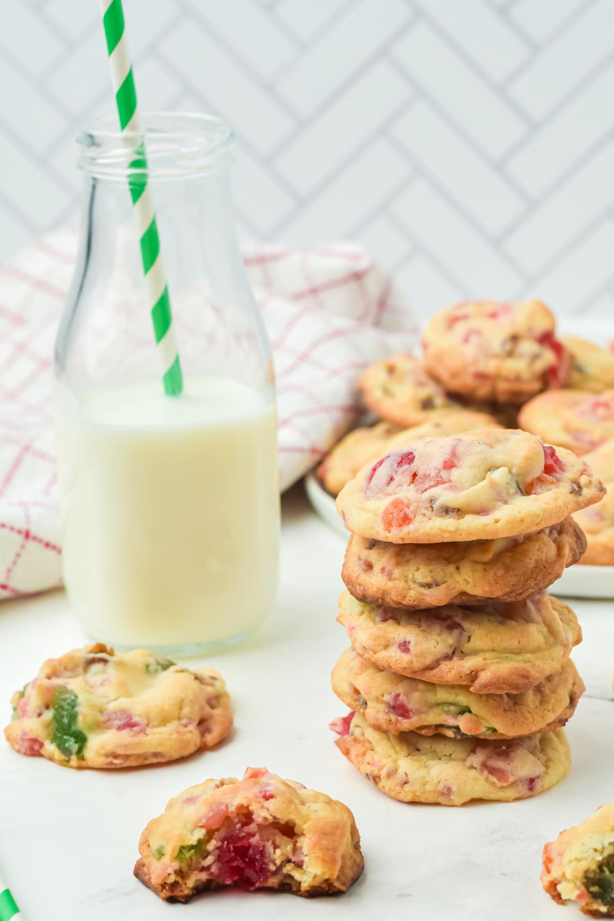 glass of milk alongside a stack of fruitcake cookies