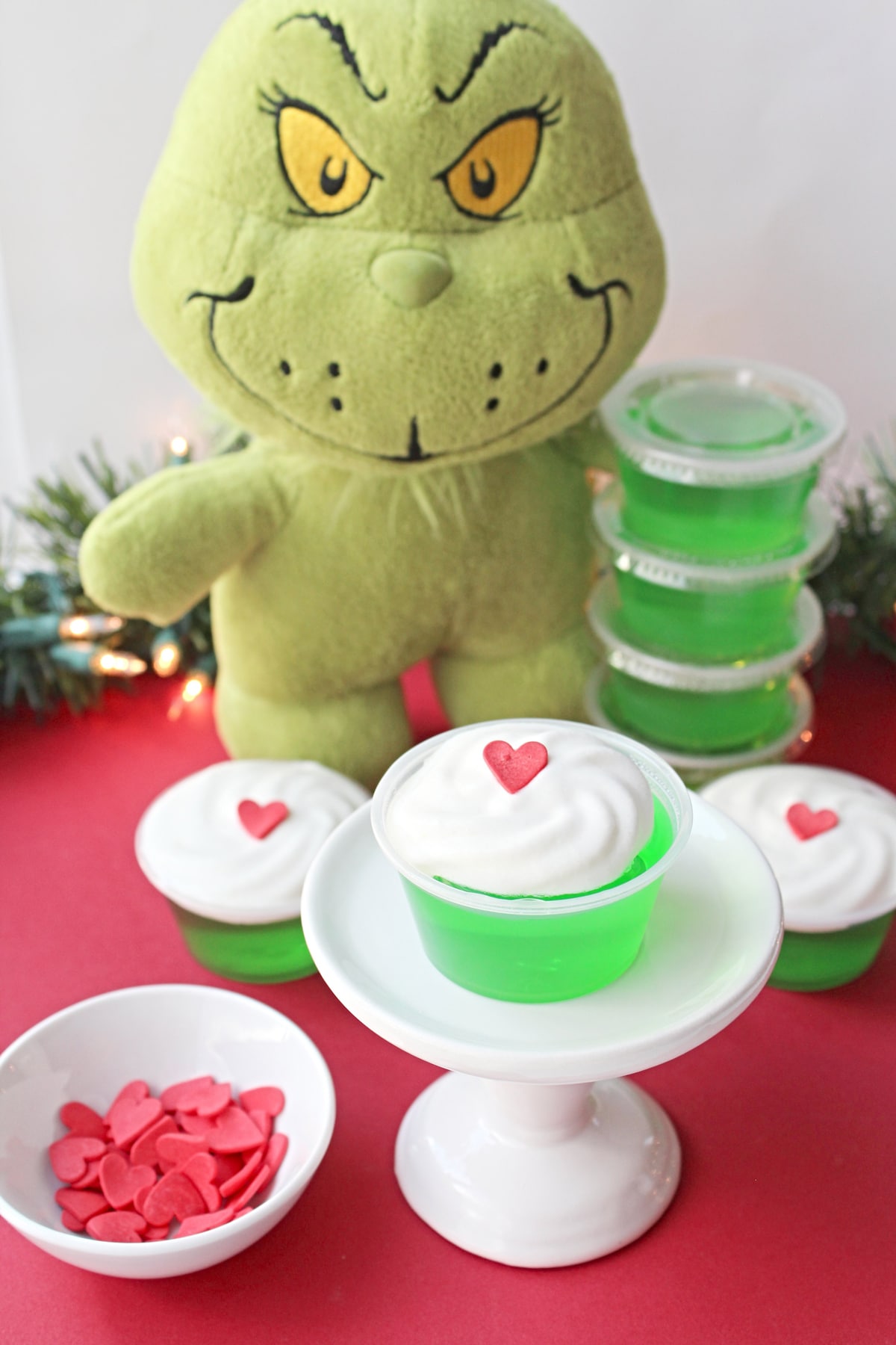 The Grinch Jello Shots with the Grinch plush character at the back.