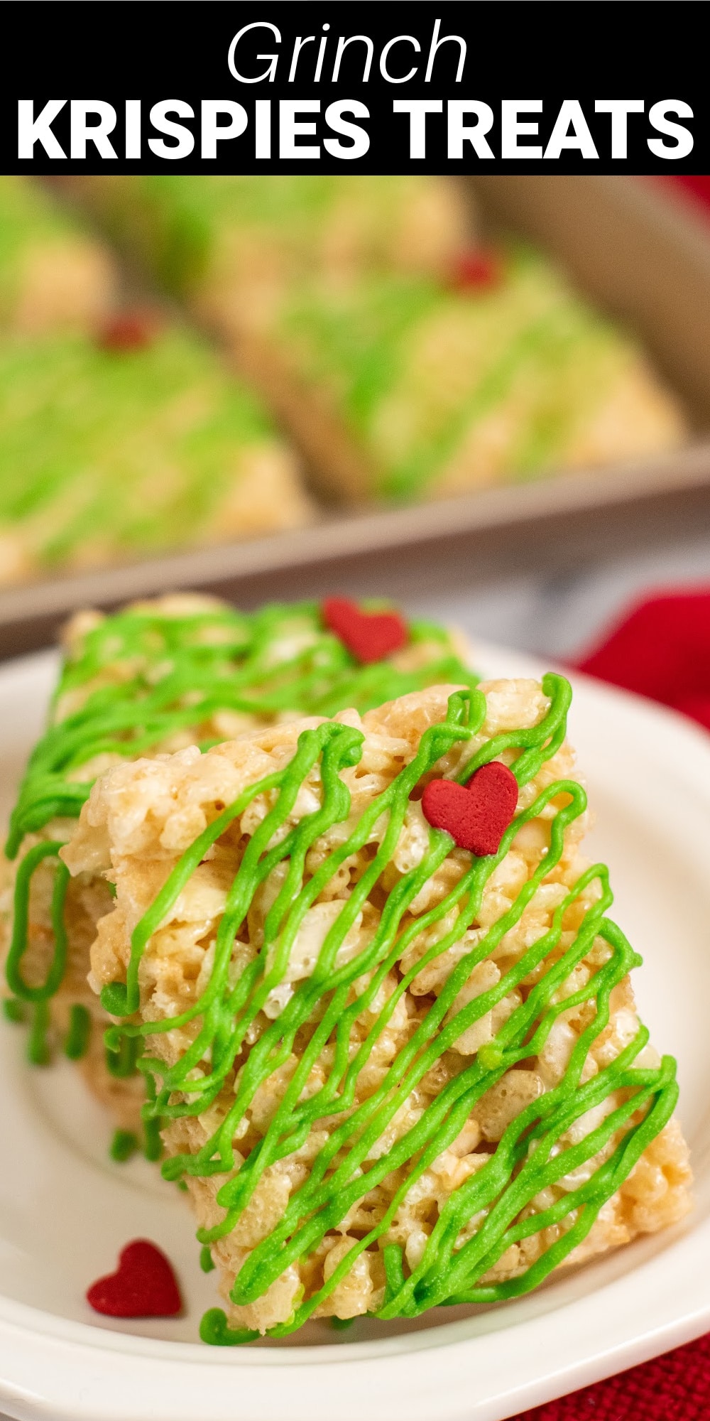 These cute Grinch Rice Krispie Treats will add a fun and festive twist to your dessert table this holiday season. Drizzled with bright green chocolate and adorned with precious little red candy hearts, these easy no-bake treats will be a hit with kids and adults alike.