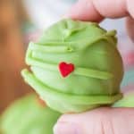 close up of light green Grinch truffle with red heart