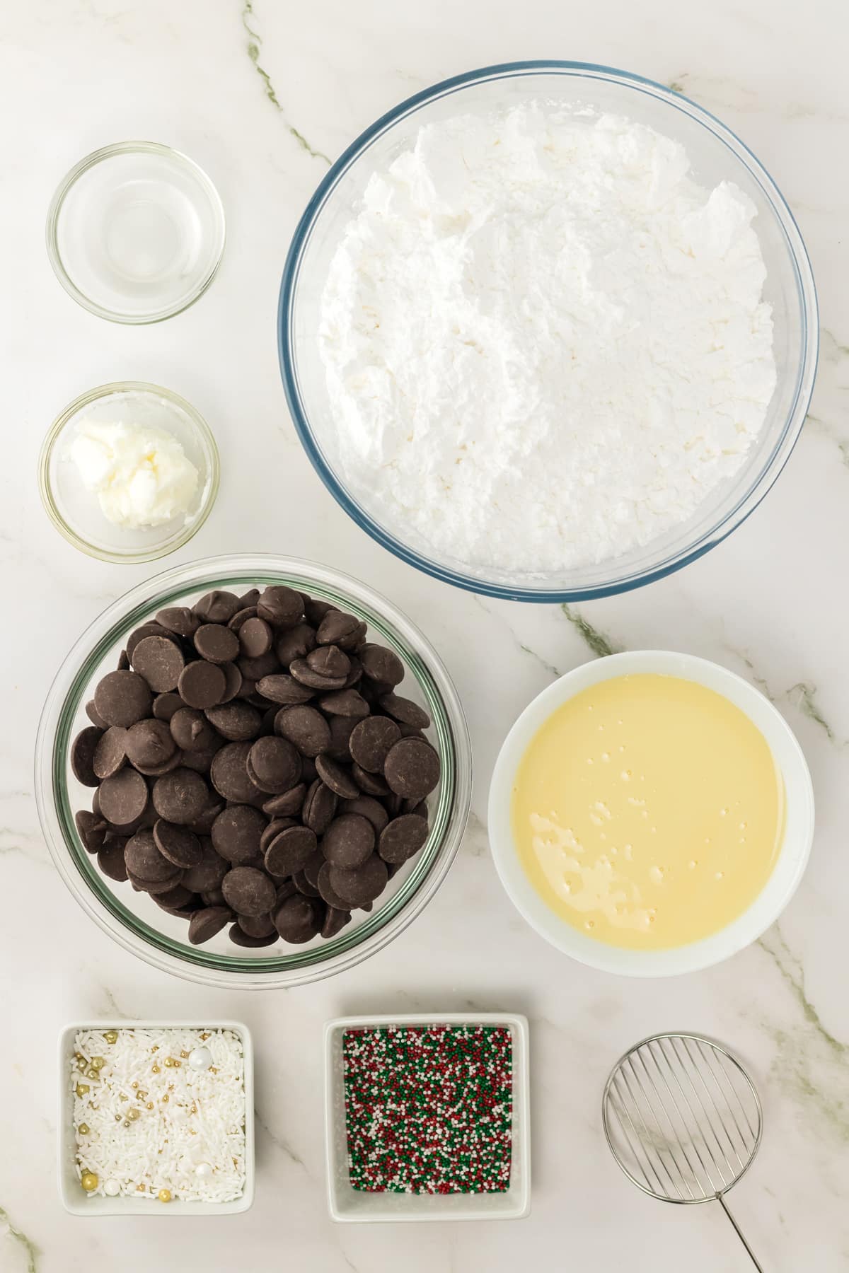 Ingredients for peppermint patties includes powdered or icing sugar, sweetened condensed milk, peppermint extract, dark chocolate wafers, vegetable shortening and assorted Christmas sprinkles