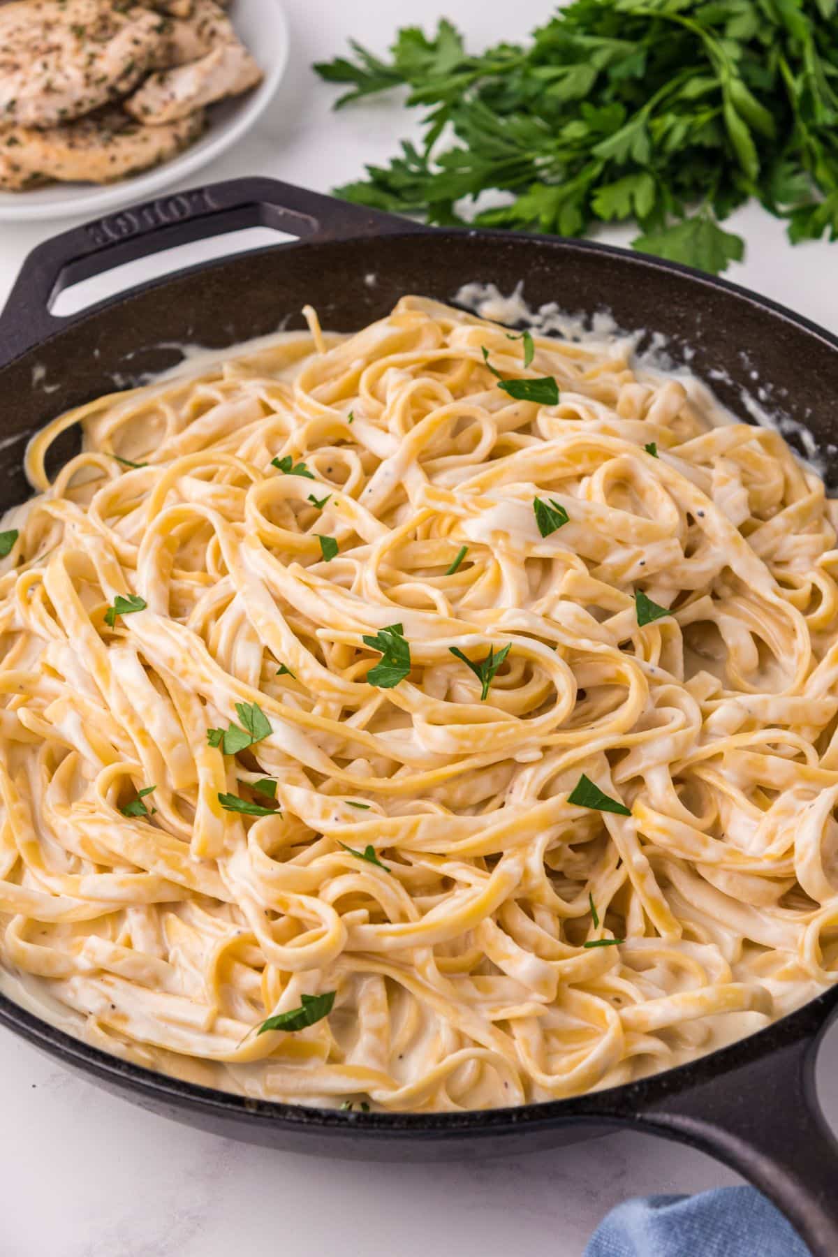 skillet of pasta with alfredo sauce on it