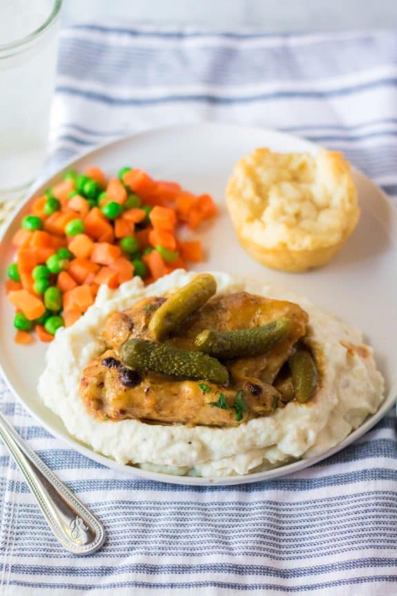 slow cooker pickle chicken recipe with utensils and linen