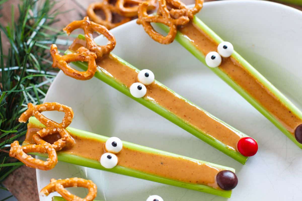 peanut butter stuffed celery wtih candy eyes and pretzel antlers