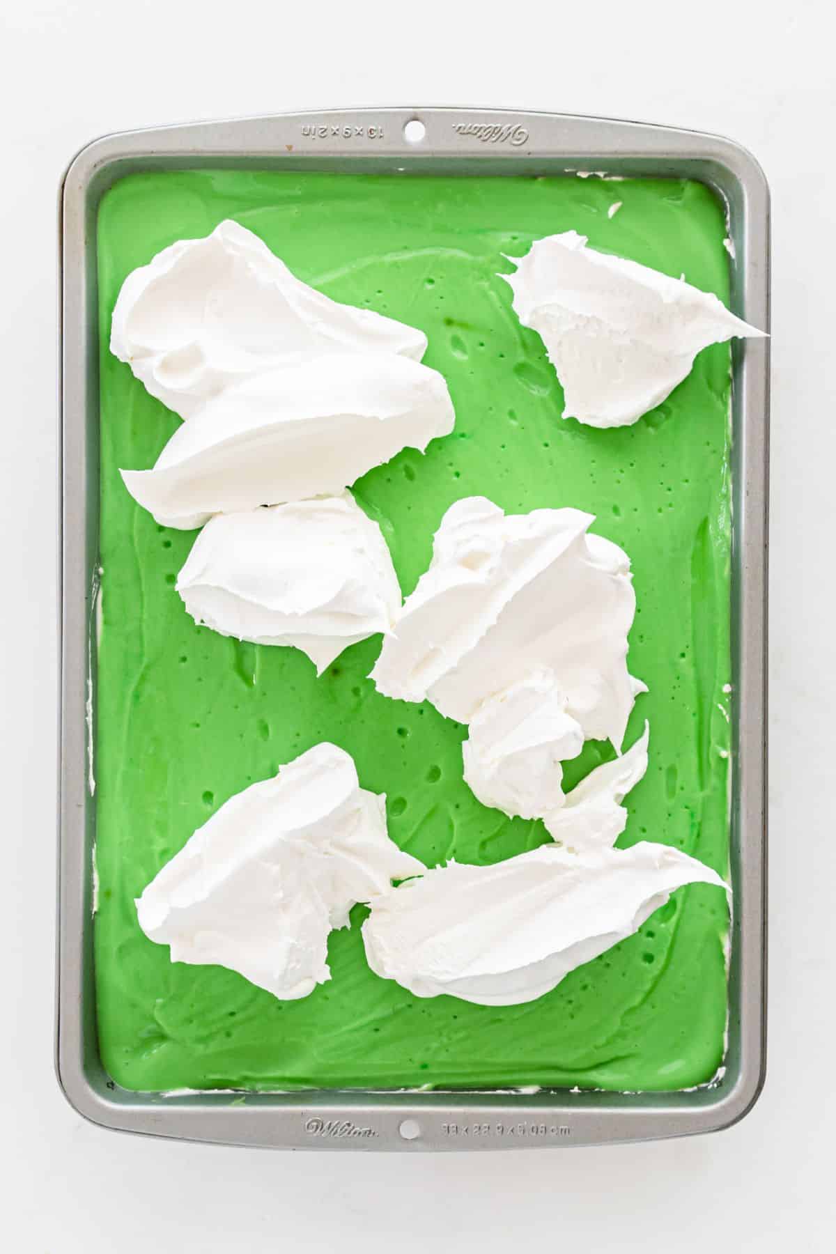 whipped cream on top of green pudding