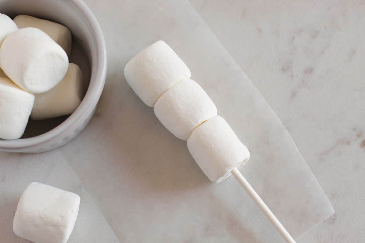 three marshmallows on popsicle stick
