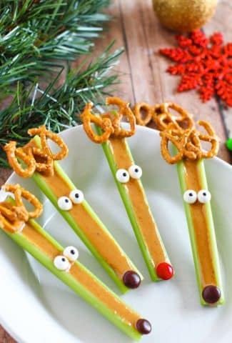 four celery stalks with peanut butter and candy eyes