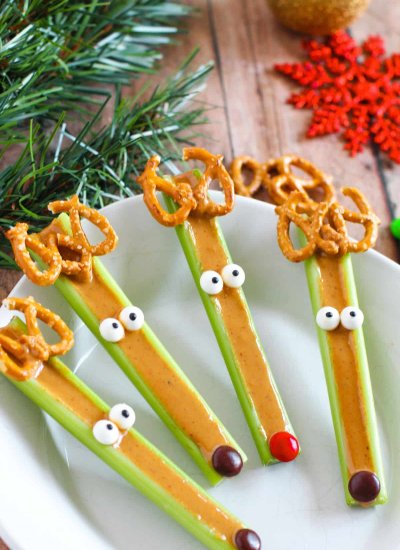 four celery stalks with peanut butter and candy eyes