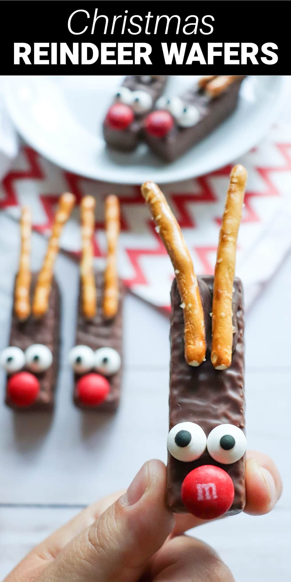 These adorable reindeer wafers turn an ordinary store-bought cookie into a festive homemade holiday treat. Melted chocolate is used to “glue” pretzel antlers, candy eyes, and M&M noses onto each cookie, turning it into a cute and fun reindeer face.