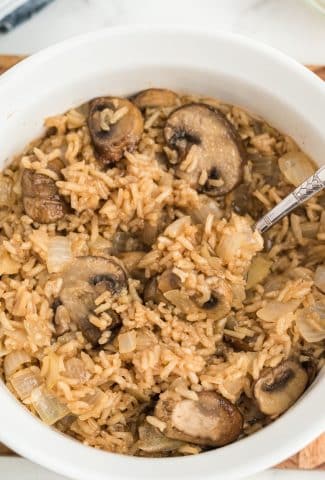 brown rice with mushrooms in white casserole dish
