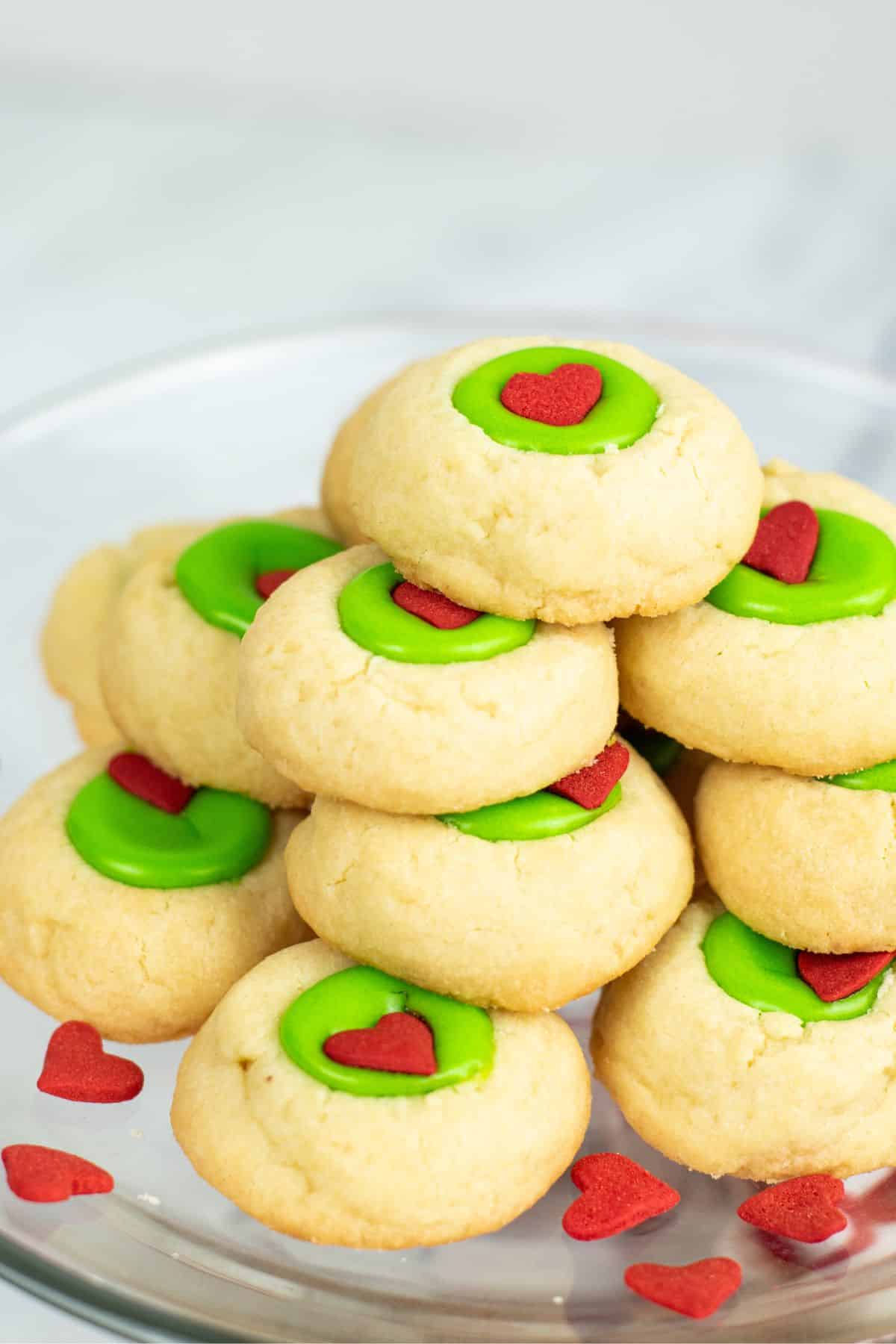 thumbprint cookies with lime green chocolate and a red heart