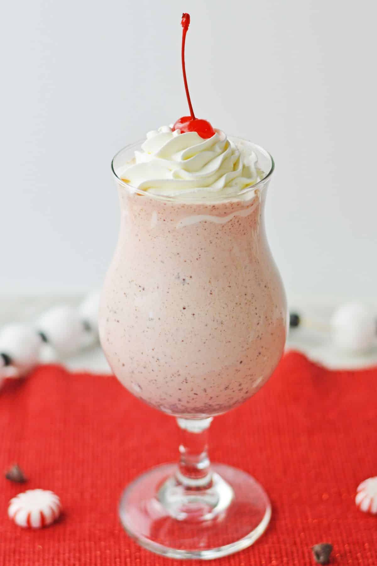 pink shake with whipped cream and cherry