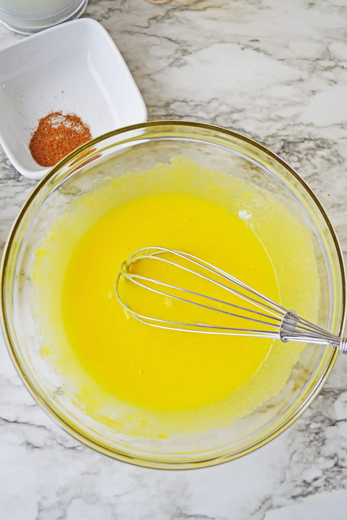 eggs in glass bowl with whisk