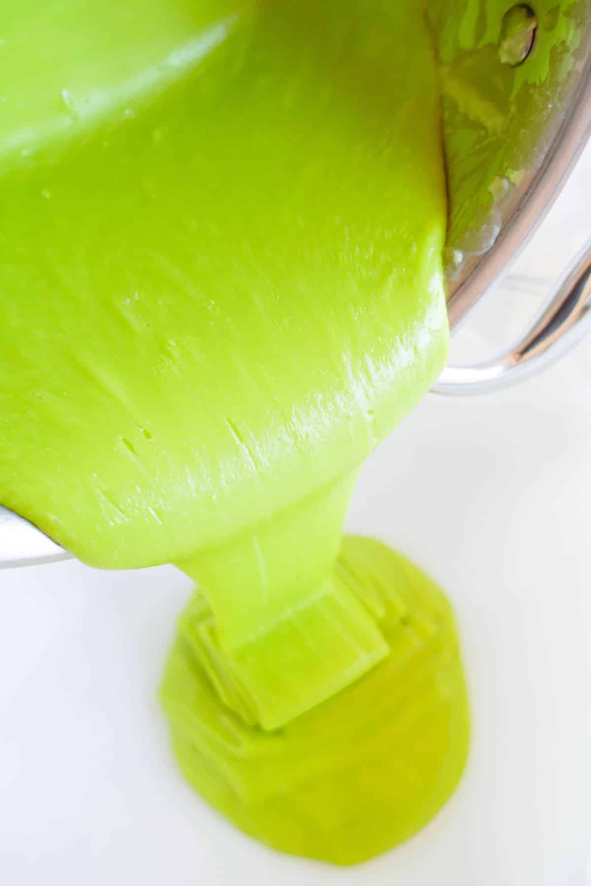 pouring green fudge into pan