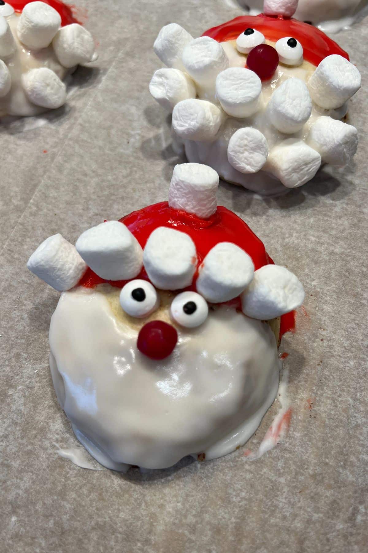 cinnamon roll decorated like Santa with red hat