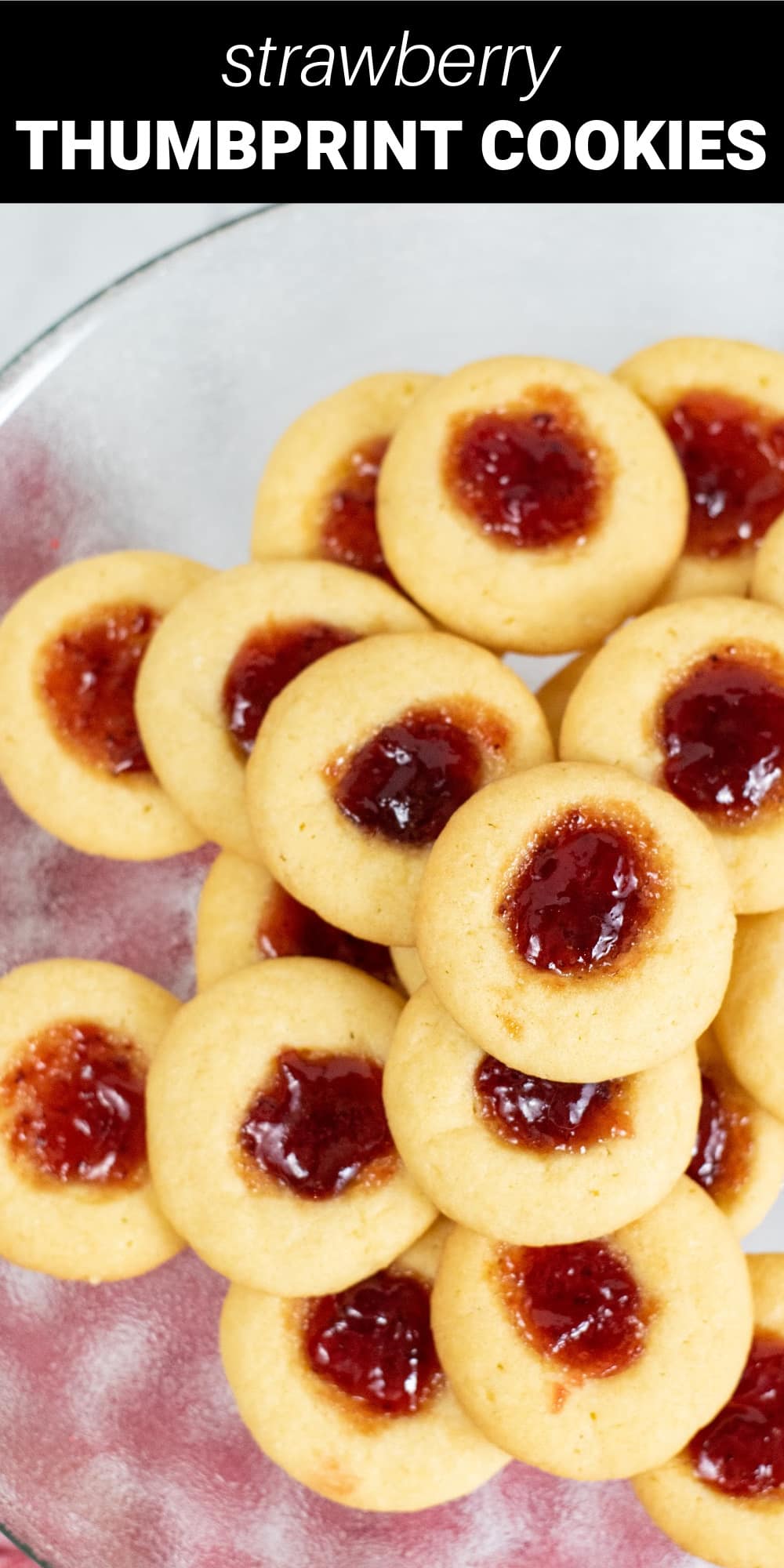 This completely irresistible Strawberry Thumbprint Cookie Recipe makes the most delicious, buttery, classic Christmas cookie with a beautiful, sweet strawberry jam center. They’ll add the perfect festive touch to all your cookie trays this holiday season.