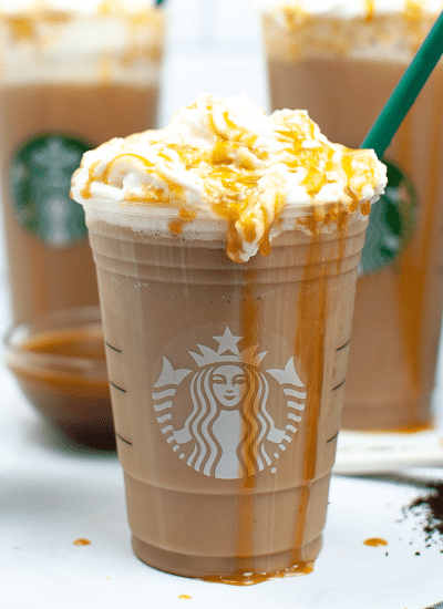 chocolate drink with whipped cream in clear Starbuck's cup