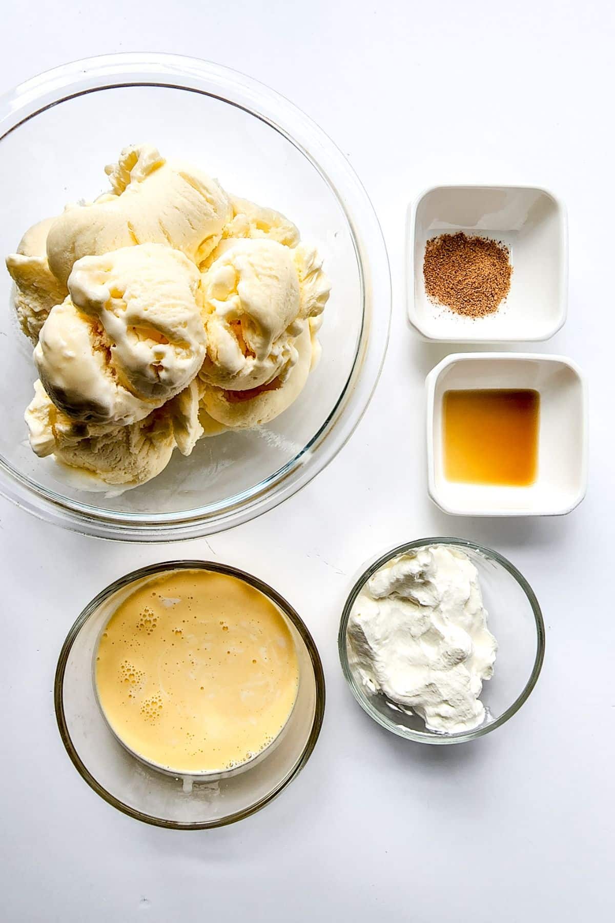 ice cream in blender, egg nog and spices on counter