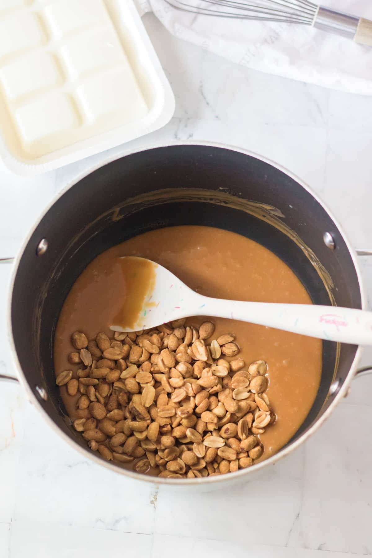 The next step of preparing Polar bear claws is to add peanuts to the melted mixture