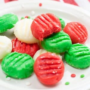 green, red, and white cream cheese disks on plate