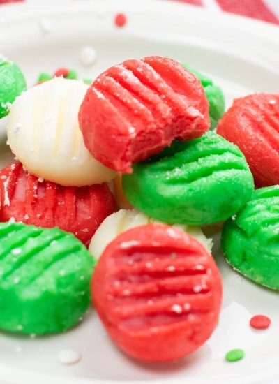 green, red, and white cream cheese disks on plate