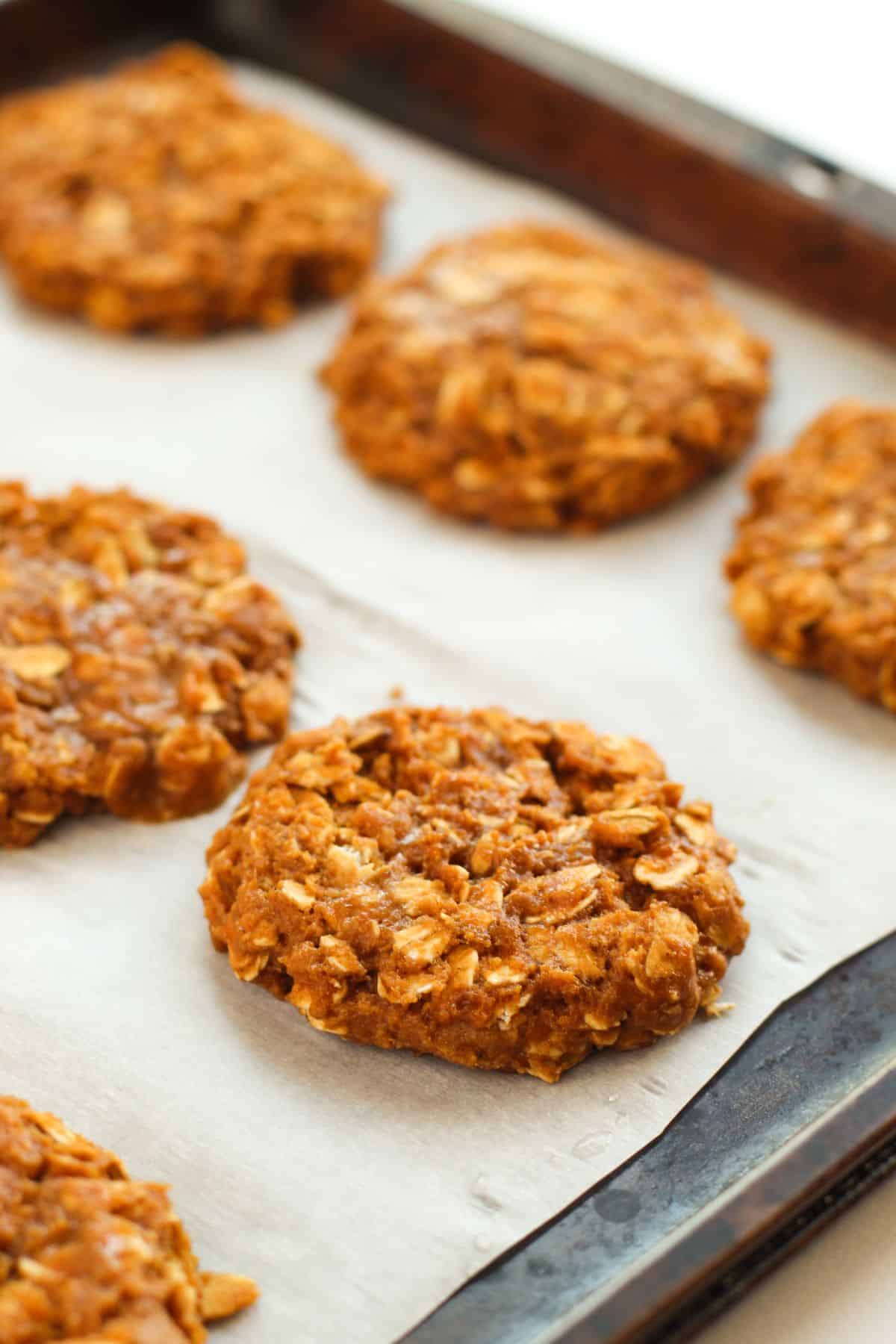 flat oatmeal cookies on baking sheet
