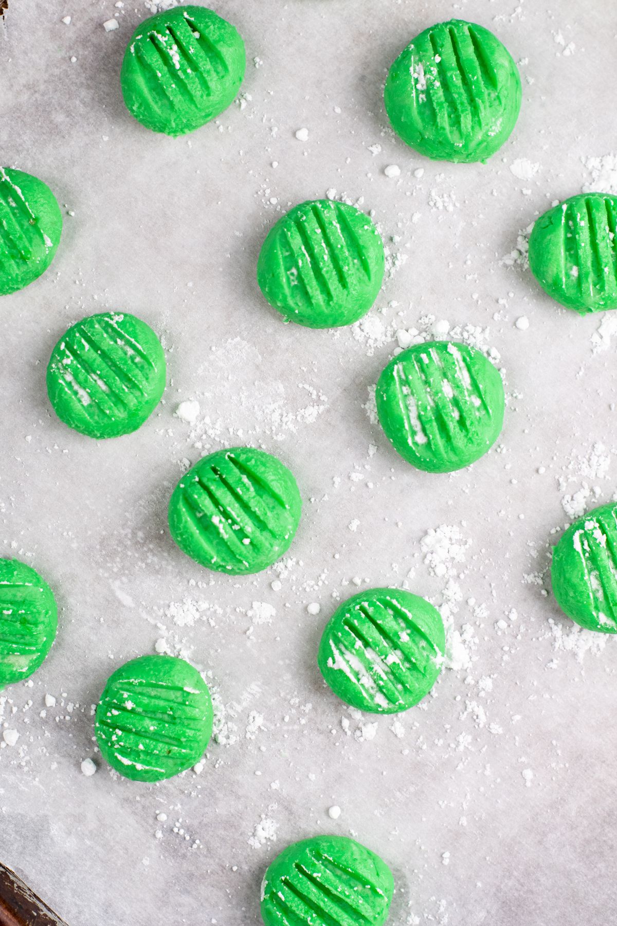 flat green mints with fork marks on parchment
