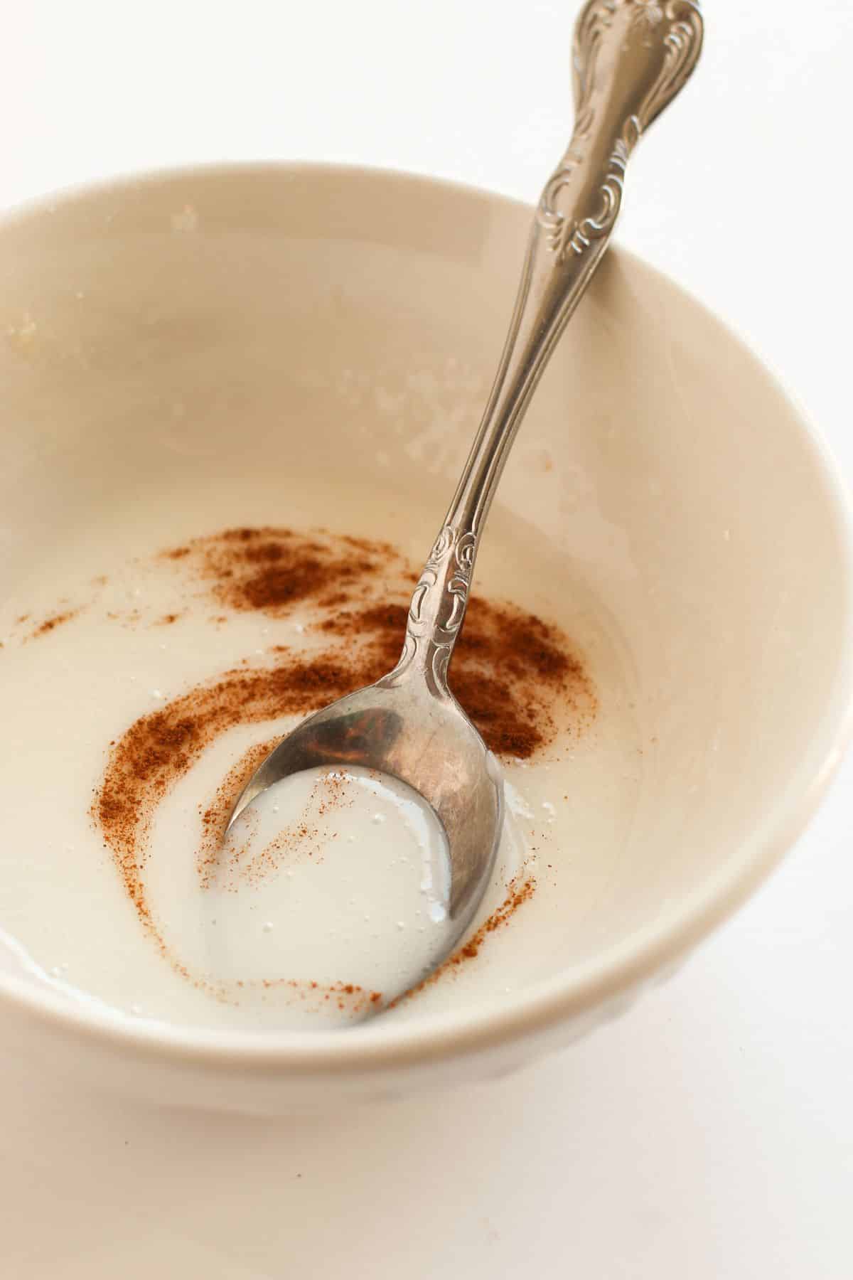 icing with cinnamon in bowl with spoon