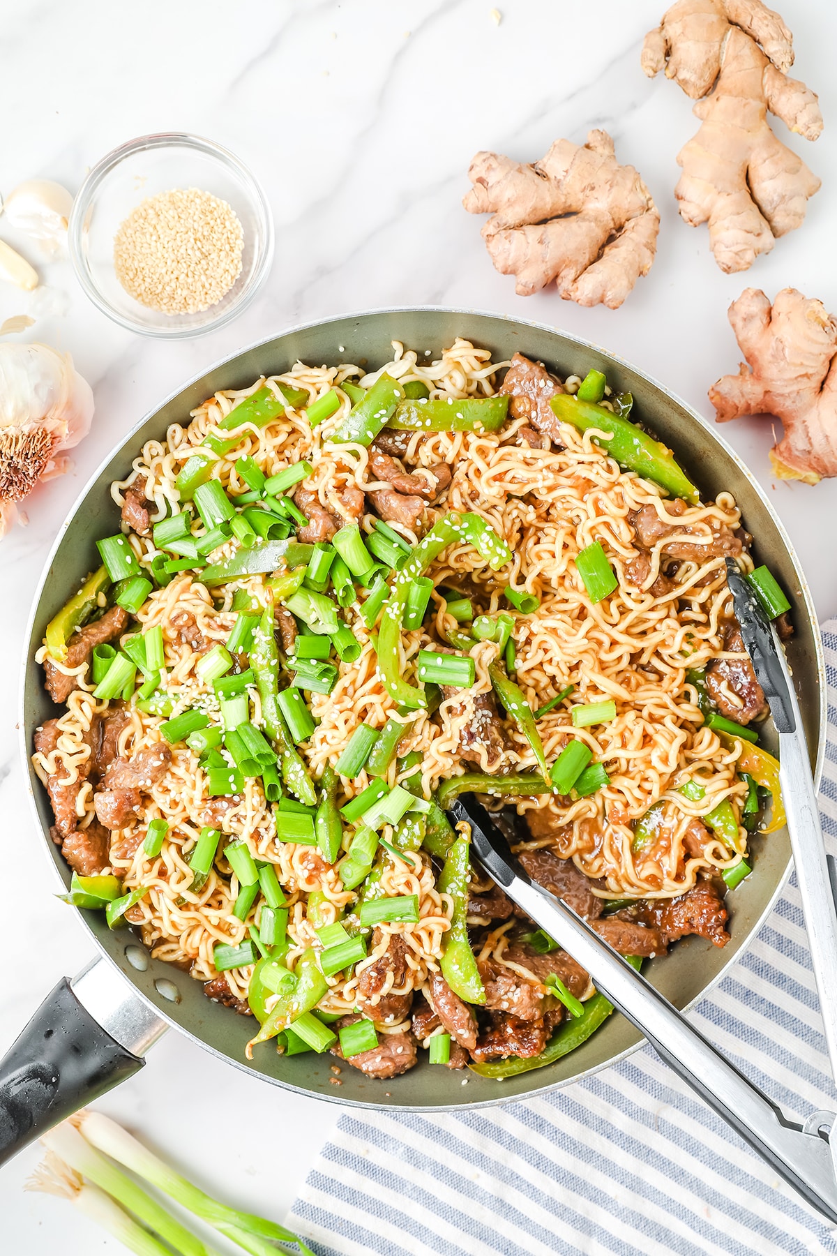 Mongolian ramen beef stir fried topped with sesame seeds and green onions
