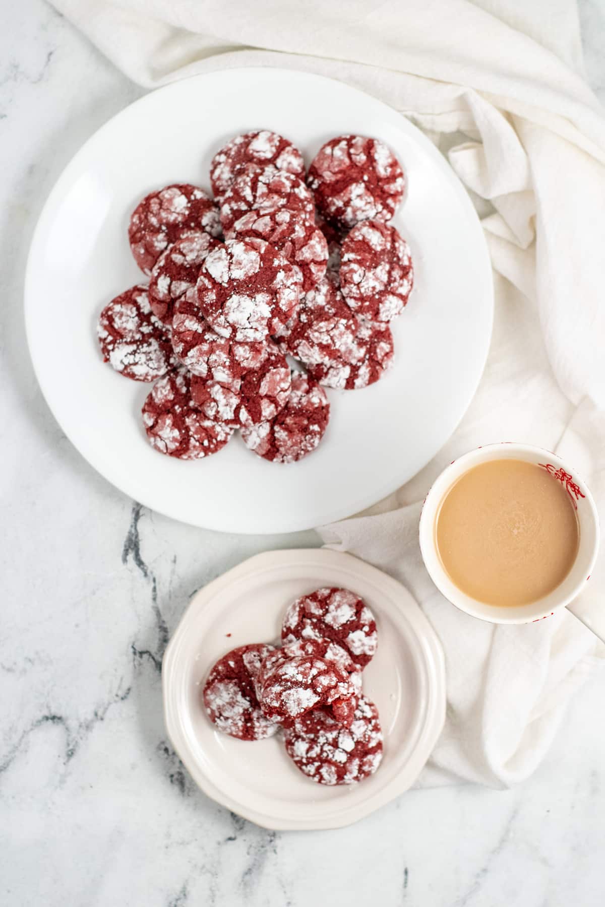 A mouthwatering red velvet crinkle cookie served with coffee.