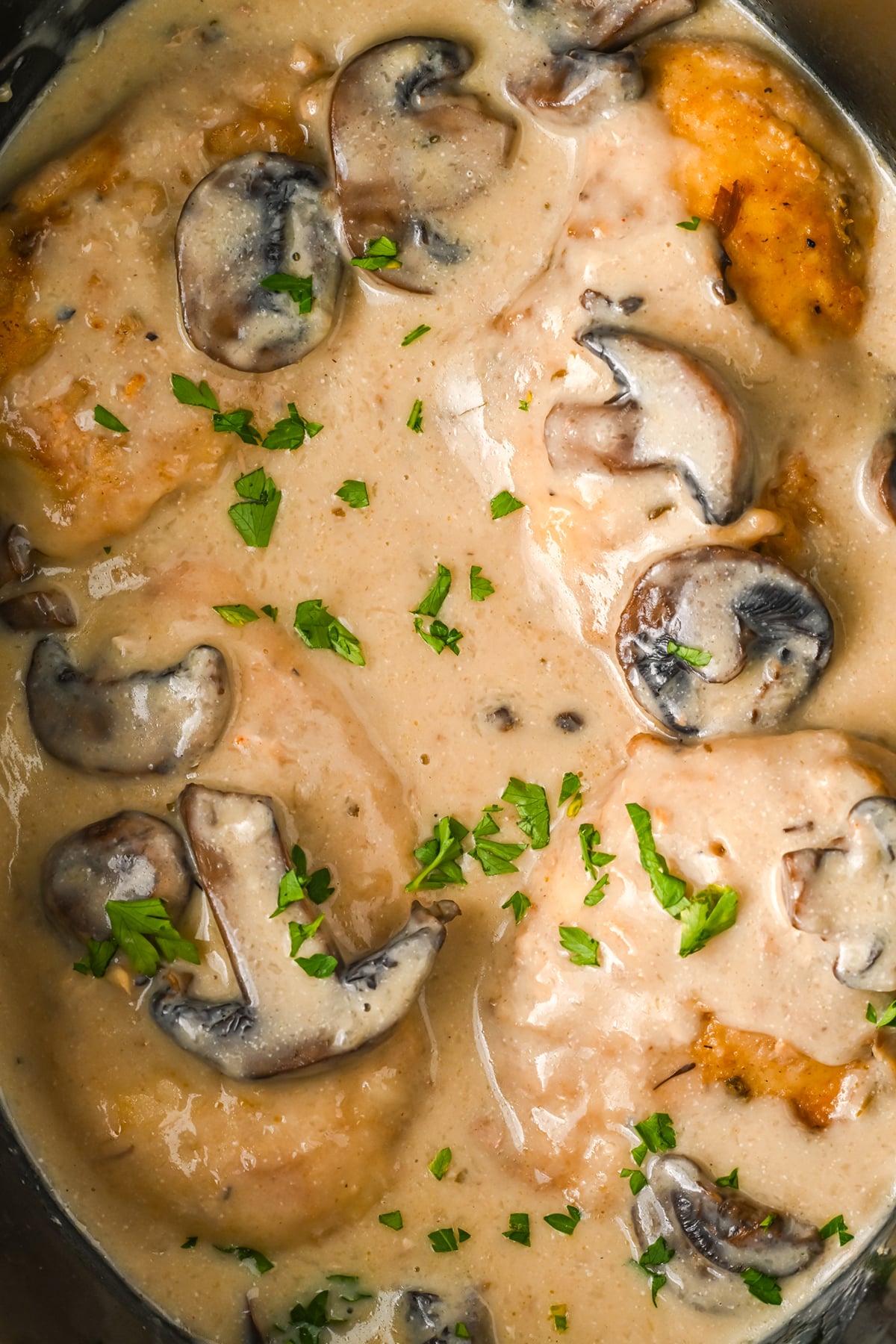 Creamy chicken marsala is cooked and garnished