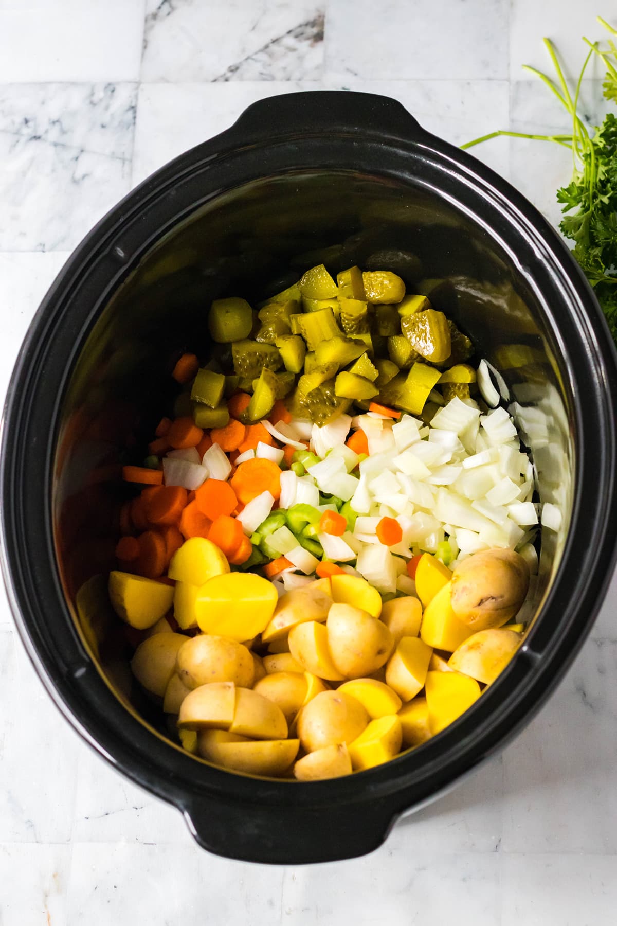 Vegetable slices were layered in the crockpot.