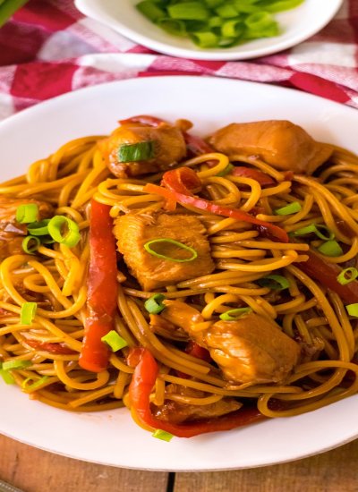 Slow cooker honey garlic chicken and noodles in a table setting