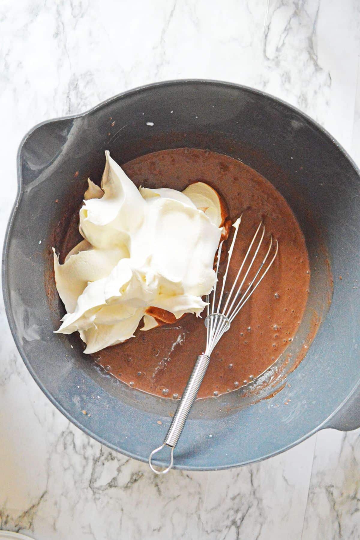 whipped topping in chocolate pudding with whisk