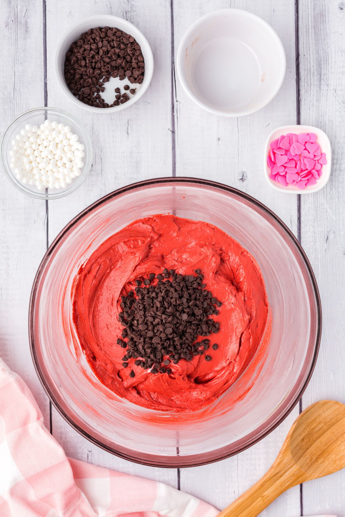 chocolate chips on top of red dip in glass bowl