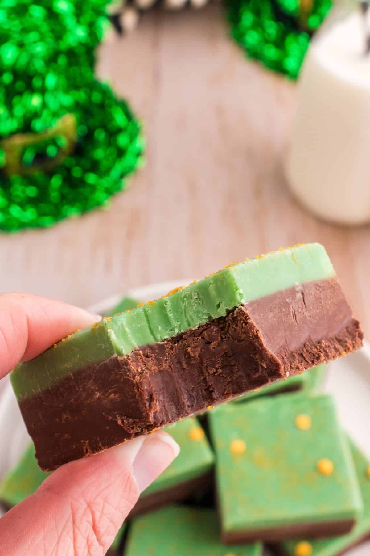 hand holding mint chocolate fudge with a bite out