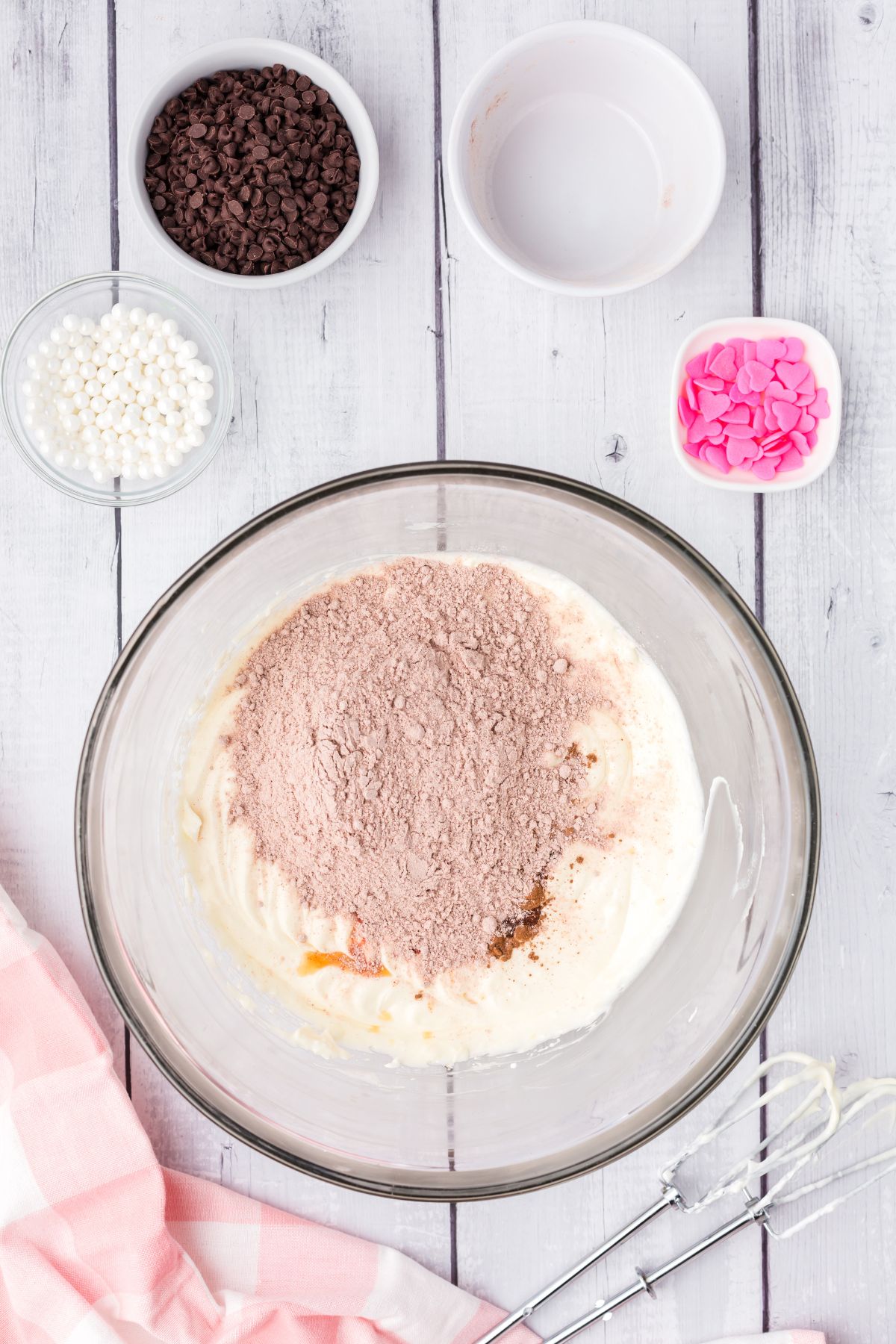 cocoa powder in bowl with white cream mixture