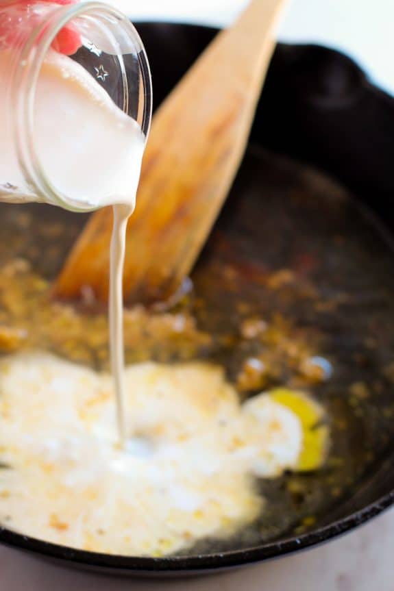pouring cream into hot skillet