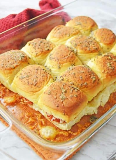 A casserole dish filled with pizza sliders.