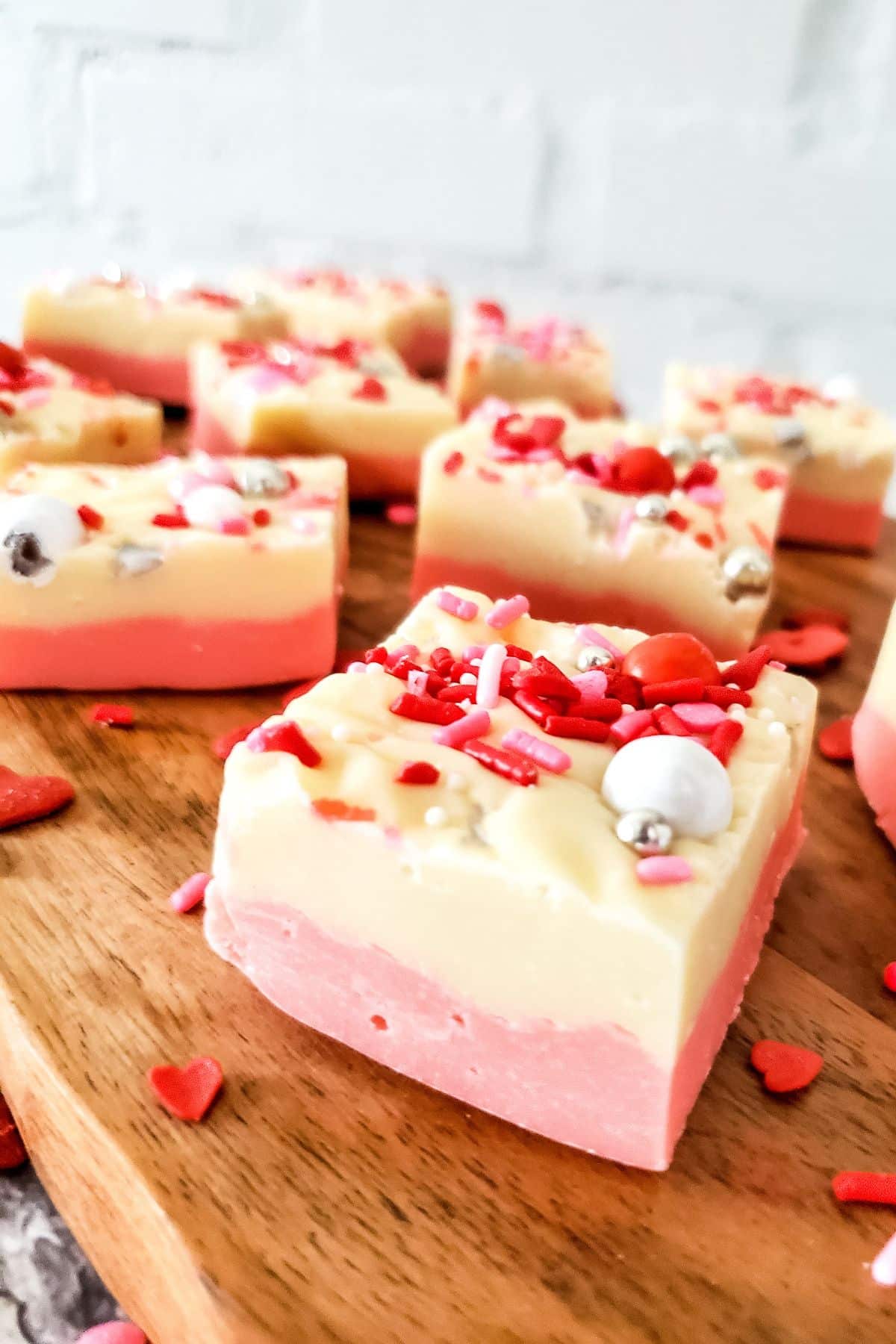 pink on bottom, white on top fudge squares with sprinkles