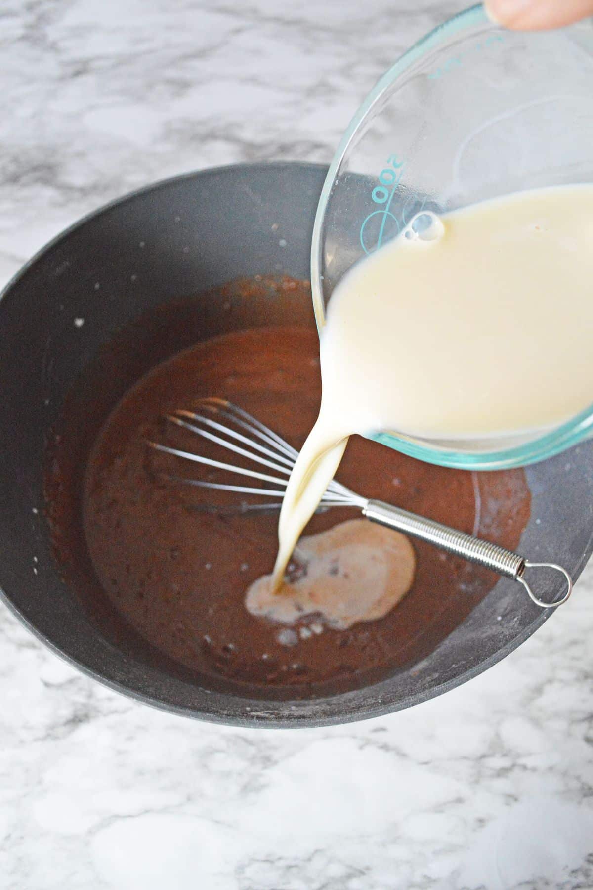 milk being poured into chocolate mixture