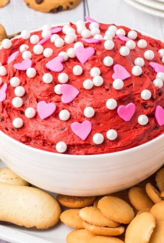 bowl of dark red dip with pink heart candies and white sprinkles