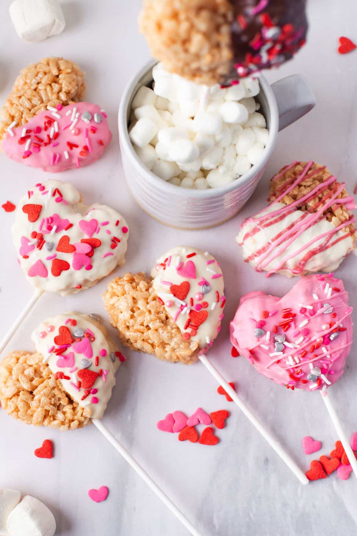 heart-shaped krispies pops with white chocolate and sprinkles
