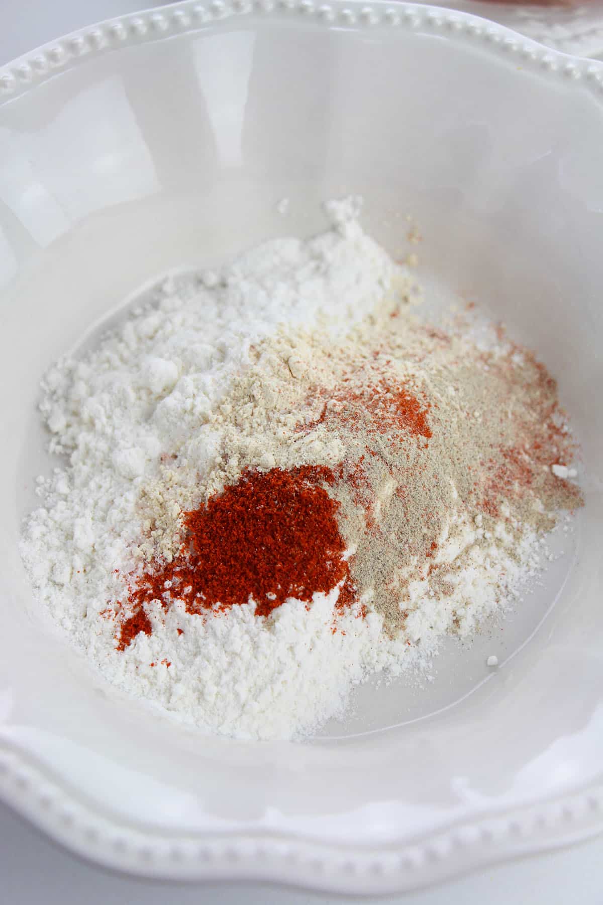 All-purpose flour and seasoning in a shallow dish