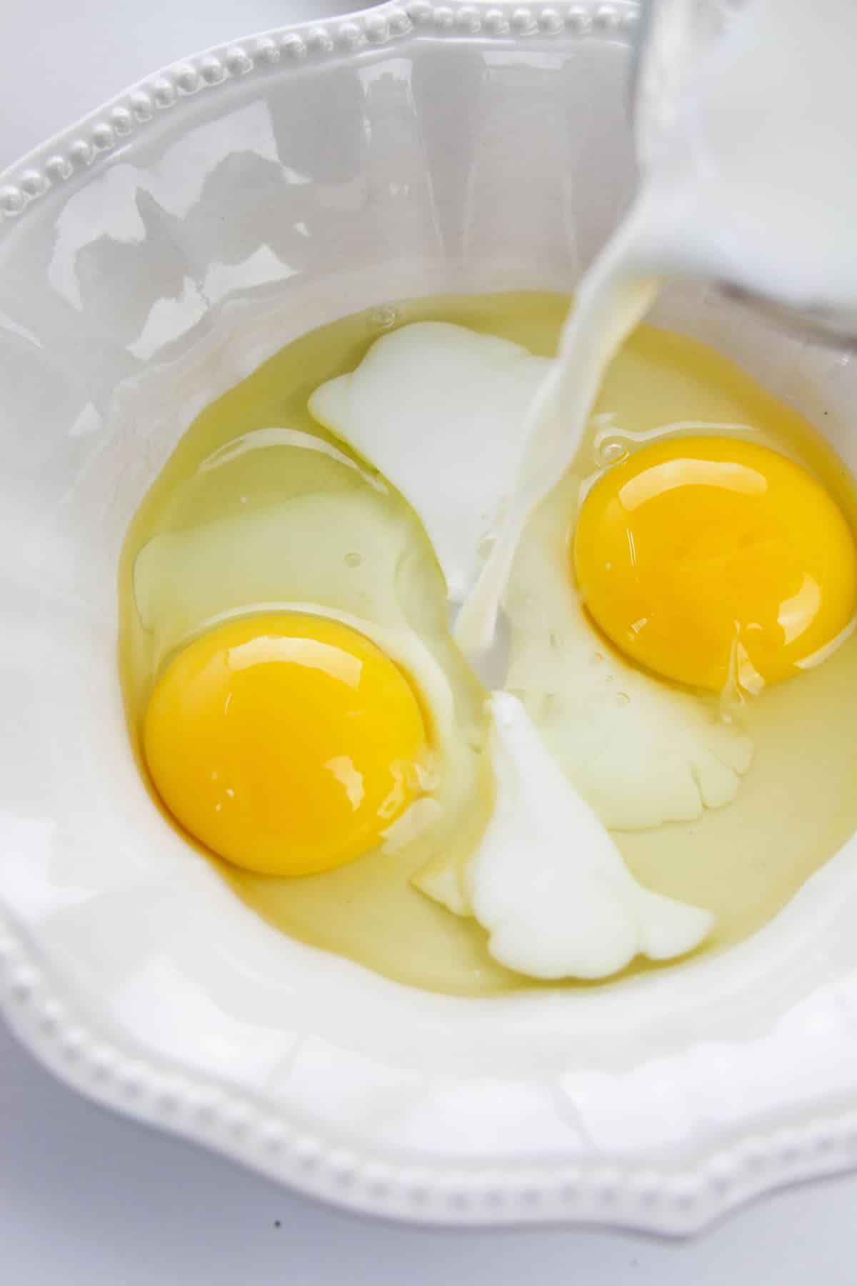 Milk and eggs in a white shallow dish