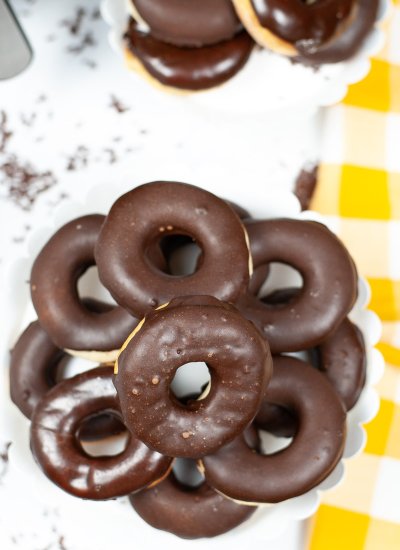 A top view of Chocolate Glazed Air Fryer Donuts on a white counter.